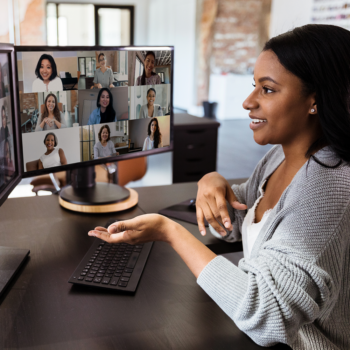 businesswoman video conferencing with Mediasite and Zoom integration on dual screen monitor